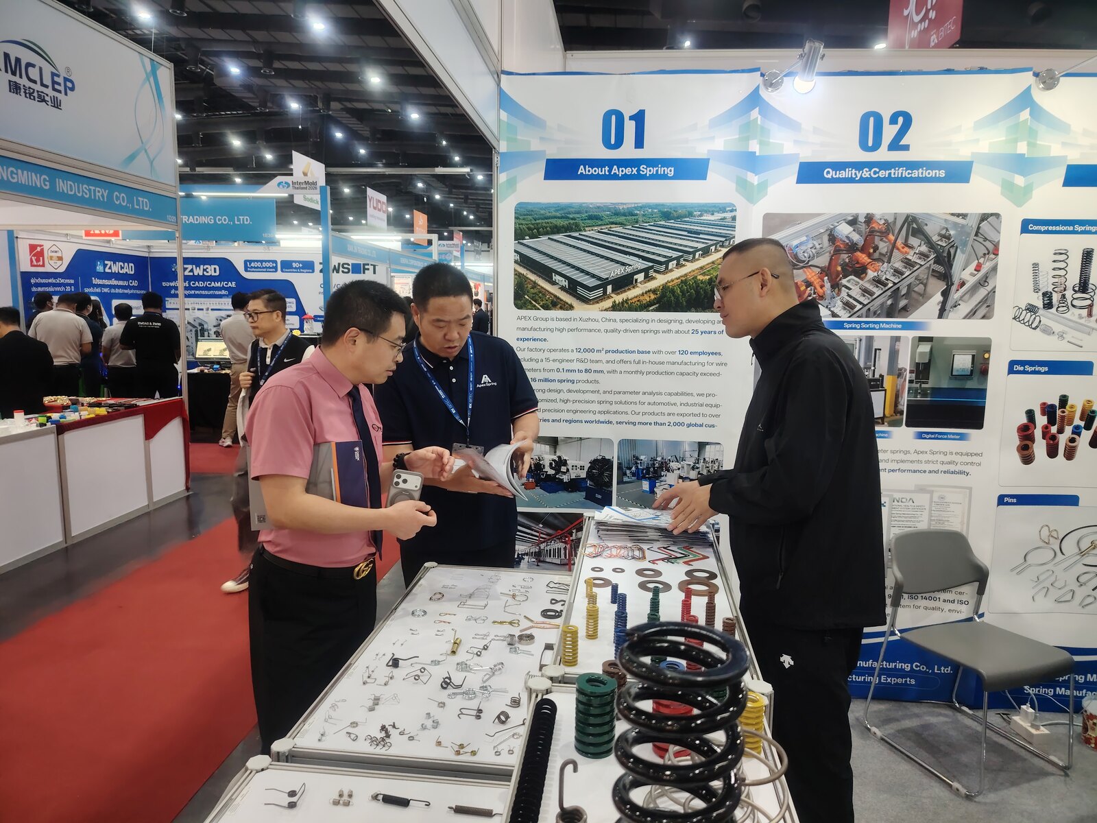 NorenSpring team discussing spring samples with a visitor
