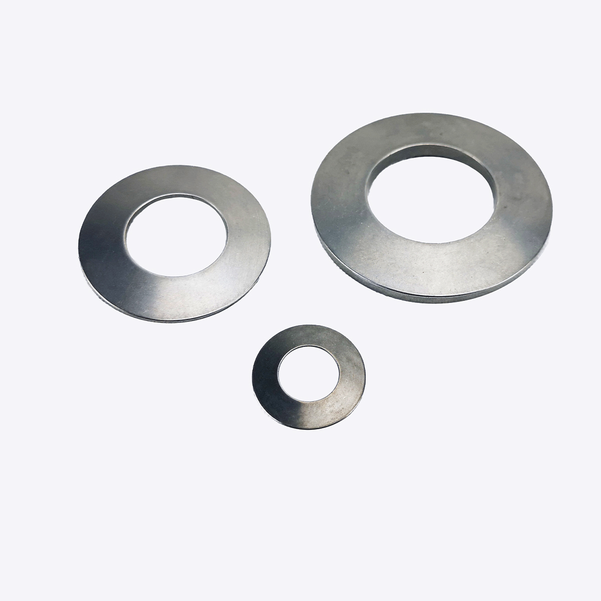 Three steel disc springs of different diameters