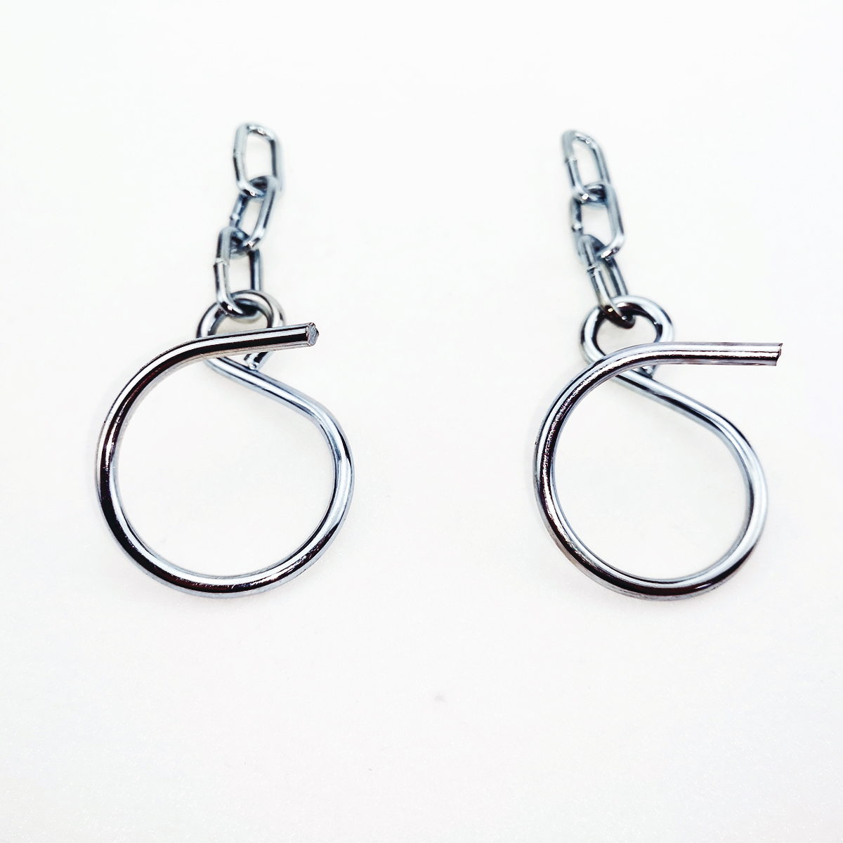 Two silver wire rings with small chain attachments