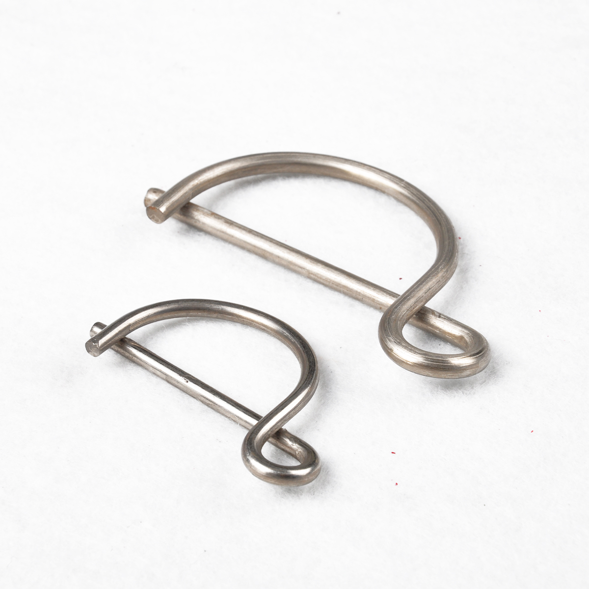 Two stainless D-shaped wire shackles in different sizes