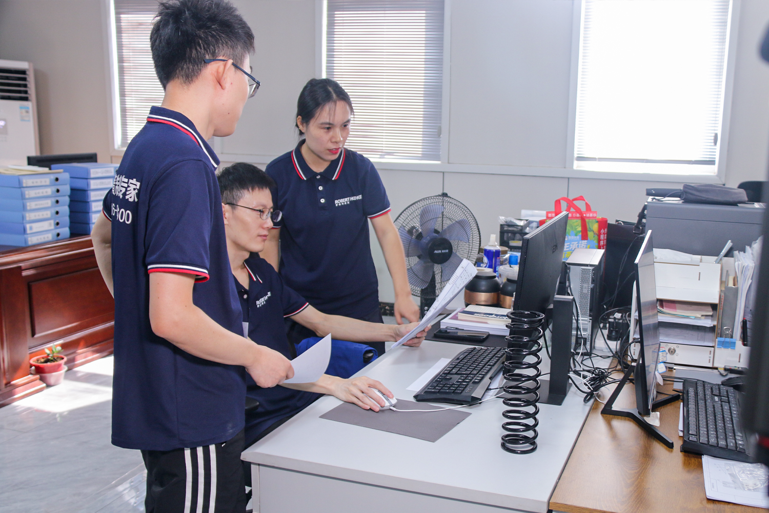Representative global engineering team reviewing spring drawings and samples